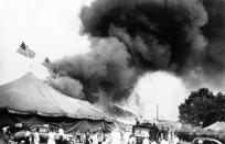<p>Flames shoot from the top of the main tent of the Ringling Bros. and Barnum and Bailey Circus during performance at Hartford, Connecticut on July 6, 1944. Shortly after, the tent collapsed, trapping many of the patrons who were still in the arena. (AP Photo) </p>