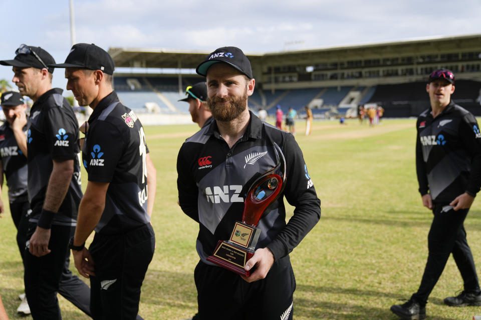 New Zealand's captain Kane Williamson hold the trophy after defeating West Indies 2-1 in a T20 series at Sabina Park in Kingston, Jamaica, Sunday, Aug. 14, 2022. (AP Photo/Ramon Espinosa)