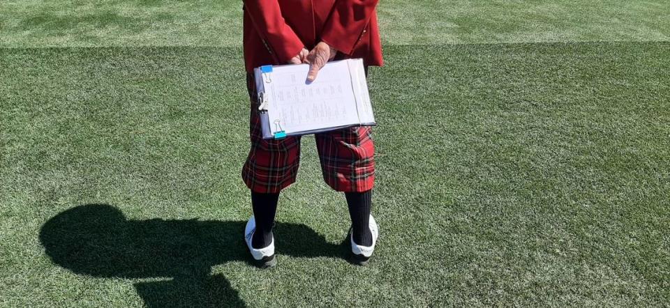 Announcer Henry Pratt holds the day’s list of tee times behind his back as he watches a player tee off Saturday at the RBC Heritage. “He’s part of the fabric of the event,” Terry Finger of the Heritage Classic Foundation says of Pratt and the pro golf tournament.