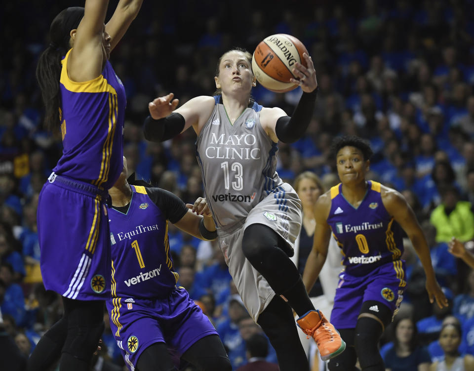 FILE - In this Sept. 26, 2017, file photo, Minnesota Lynx guard Lindsay Whalen (13) goes to the basket against the Los Angeles Sparks during the second half of Game 2 of the WNBA finals in Minneapolis. The Minnesota Lynx will honor Lindsay Whalen with a ceremony this season to mark the first jersey retirement by the 20-year-old franchise. The Lynx announced Thursday, April 18, 2019, they will hang Whalen’s number 13 from the Target Center rafters, at their June 8 game against the rival Los Angeles Sparks. (Aaron Lavinsky/Star Tribune via AP, File)