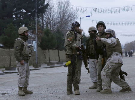 Members of Afghan Quick Reaction Force (QRF) talk among themselves during an operation near the Indian consulate in Mazar-i-Sharif, Afghanistan January 4, 2016. REUTERS/Anil Usyan