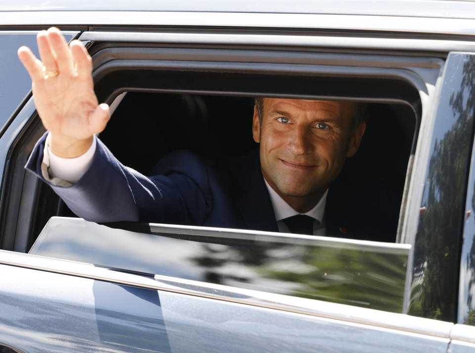 France's President Emmanuel Macron waves as he leaves the polling station after voting in the first round of French parliamentary election in Le Touquet, northern France, Sunday June 12, 2022. French voters are choosing lawmakers in a parliamentary election as President Emmanuel Macron seeks to secure his majority while under growing threat from a leftist coalition. More than 6,000 candidates, ranging in age from 18 to 92, are running for 577 seats in the National Assembly in the first round of the election. (Ludovic Marin, Pool via AP)