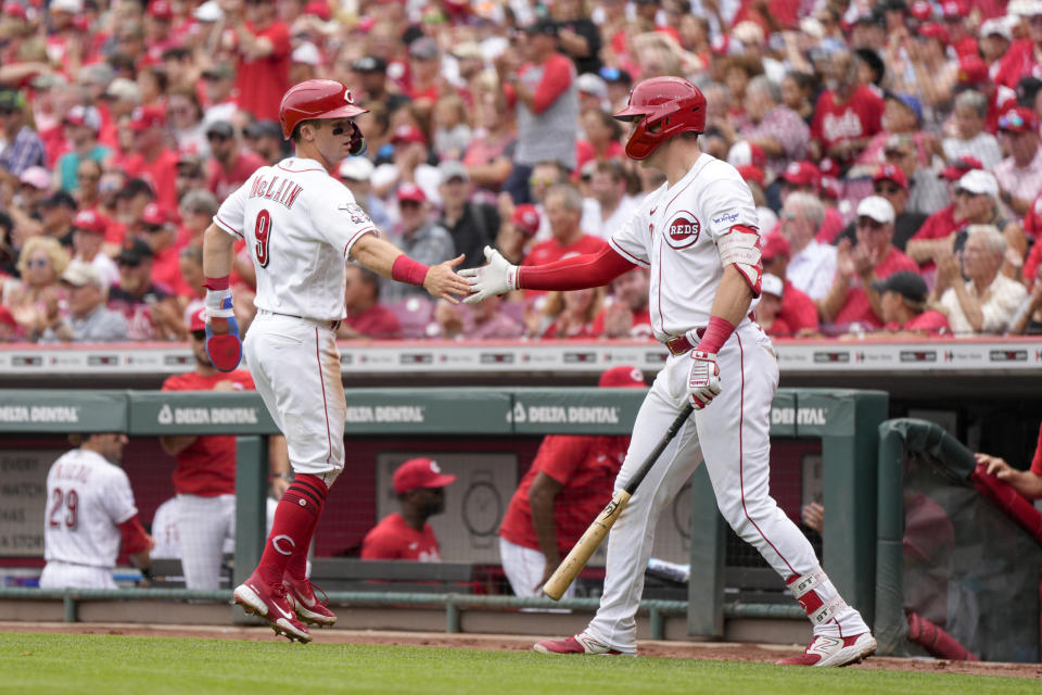 Cincinnati Reds' Matt McLain (9) celebrates with Tyler Stephenson after scoring on a single hit by Christian Encarnacion-Strand during the sixth inning of a baseball game against the Miami Marlins Wednesday, Aug. 9, 2023, in Cincinnati. (AP Photo/Jeff Dean)