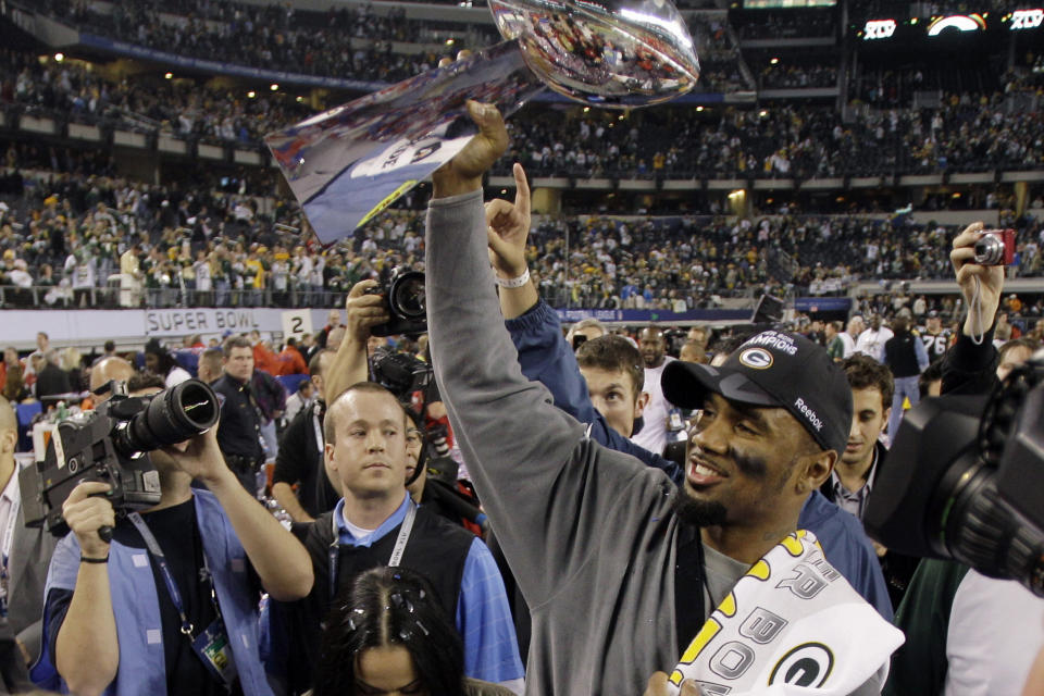FILE - In this Feb. 6, 2011, file photo, Green Bay Packers' Charles Woodson holds up the Vince Lombardi Trophy while celebrating the Packers' 31-25 win against the Pittsburgh Steelers in NFL football's Super Bowl XLV in Arlington, Texas. Woodson, in his first-year of eligibility, was selected as a finalist for the Pro Football Hall of Fame's class of 2021 on Tuesday, Jan. 5, 2021. (AP Photo/Eric Gay, File)