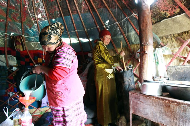 FILE PHOTO: Farmers make "kumis" inside a yurt at a high altitude summer pasture called Suusamyrin, south of the capital Bishkek