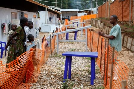 Desy Shabani, a psycho-social assistant, talks to suspected Ebola patients at an Ebola treatment centre in Butembo