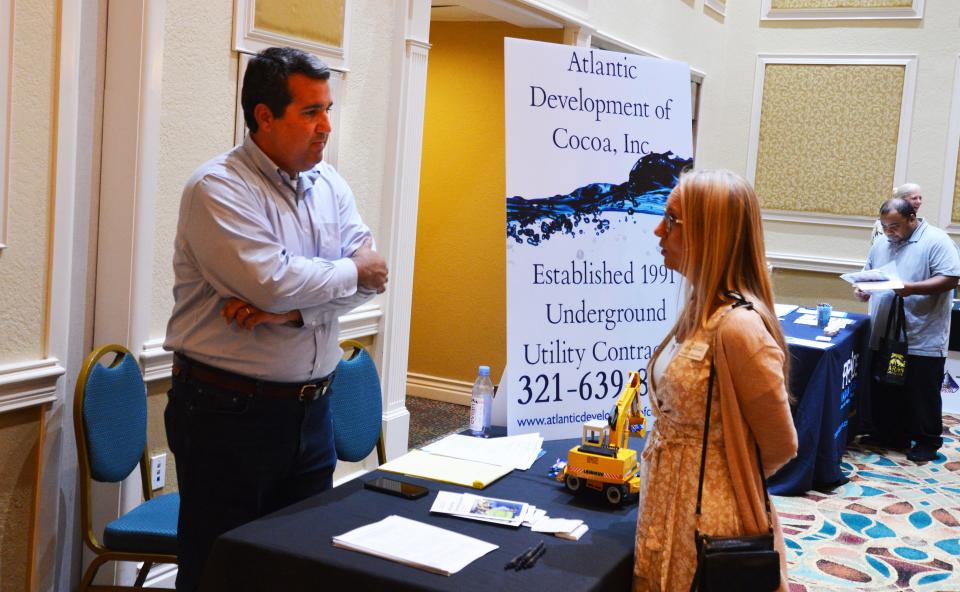 Tyler Sirois, left, human resources director Atlantic Development of Cocoa Inc., talks with a visitor to the recent CareerSource Brevard job fair in Cape Canaveral.