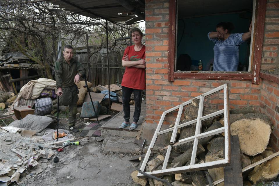Local residents stand by their damaged house hit by recent shelling, what local officials called a Ukrainian military strike, in Horlivka (Gorlovka), Russian-controlled Ukraine (AFP via Getty Images)