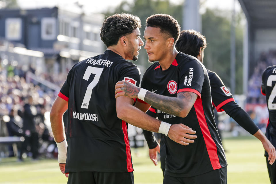 Frankfurt's Lucas Tuta-Silva Melo celebrates after scoring his side's fourth goal, with Omar Marmoush, during the Bundesliga soccer match between Holstein Kiel and Eintracht Frankfurt, at the Holstein Stadium in Kiel, Germany, Sunday, Sept. 29, 2024. (Frank Molter/dpa via AP)