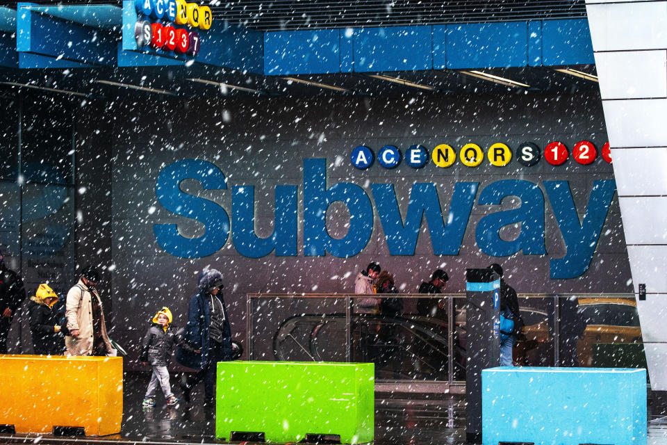 People make their way around Times Square during a winter storm in New York, Sunday, Jan. 7, 2024. (AP Photo/Eduardo Munoz Alvarez)