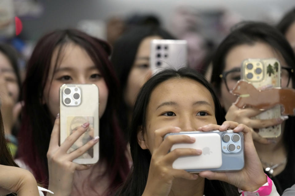 Fans record on their cell phones at KCON at the Los Angeles Convention Center on Friday, Aug. 18, 2023. (AP Photo/Chris Pizzello)