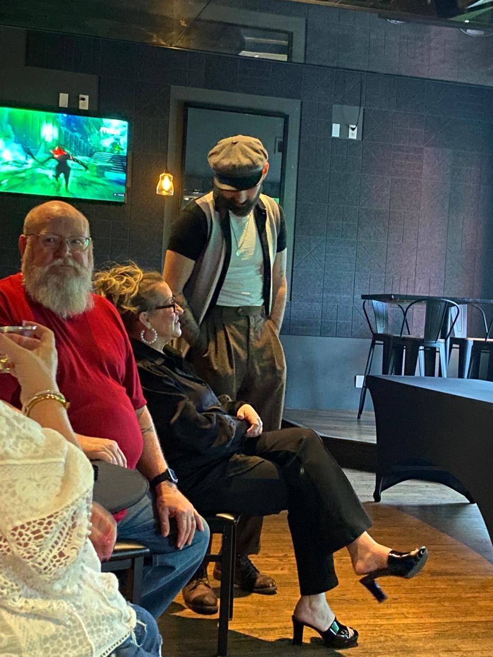 Chef Zach Hutton, standing center, speaks with his mom ahead of an April 9 viewing of his "Chopped" episode during a watch party at Ponyboy in Oklahoma City.