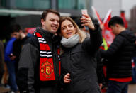 <p>Fans pose for selfies outside Old Trafford </p>