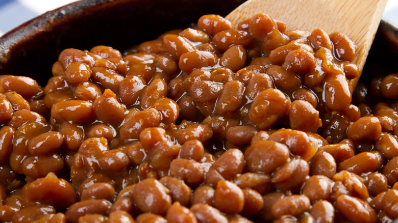 Baked beans with wooden spoon