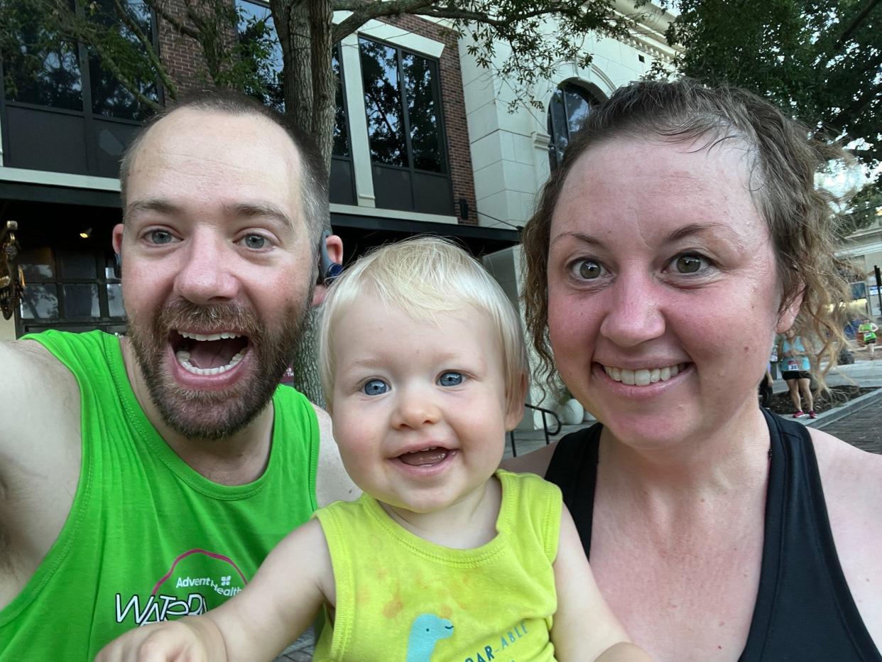 Gabrielle Russon (right), her husband Brent (left), and their baby doing a 5K run on July 4, 2022 in Winter Park, Fl.