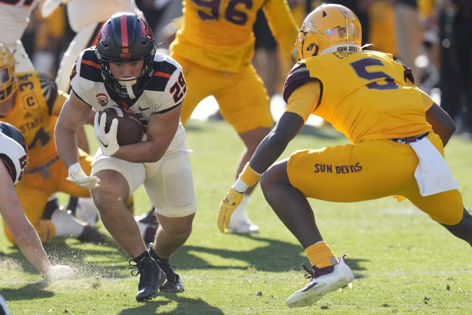 Oregon State running back Kanoa Shannon runs with the ball as he tries to elude Arizona State defensive back Chris Edmonds Saturday, Nov. 19, 2022. Edmonds leads Arizona State with 52 tackles | Ross D. Franklin, Associated Press