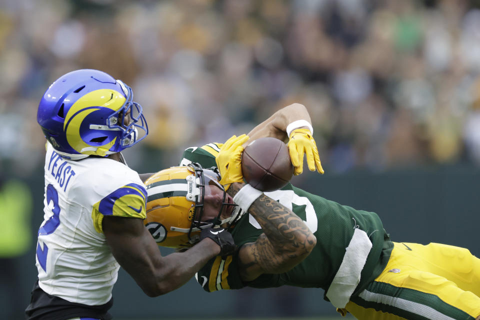 Green Bay Packers wide receiver Christian Watson (9) catches a pass while defended by Los Angeles Rams safety Russ Yeast (2) during the second half of an NFL football game Sunday, Nov. 5, 2023, in Green Bay, Wis. (AP Photo/Matt Ludtke)