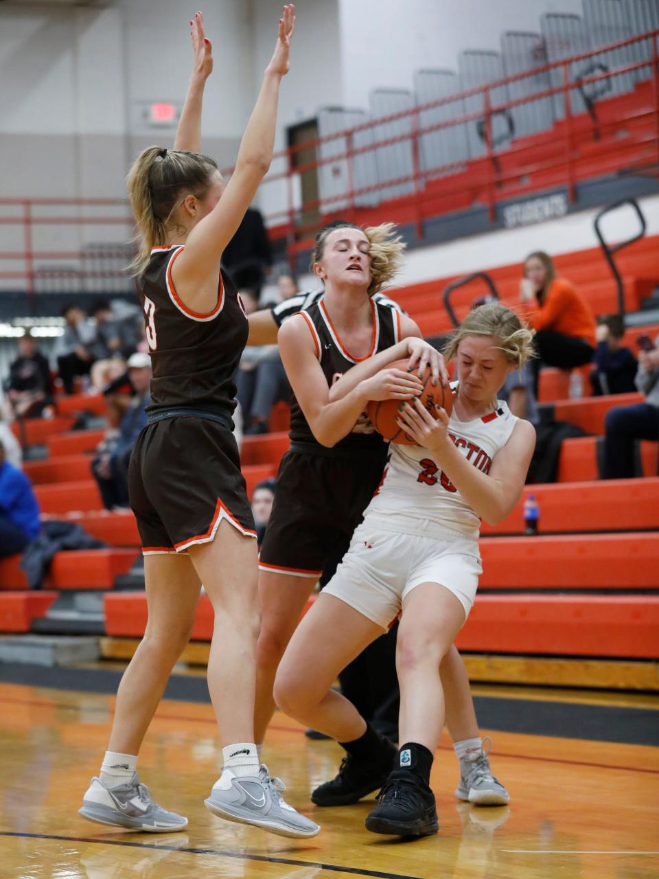 Coshocton's Hailey Helter fights for possession with Meadowbrook's Karly Launder, left, and Kenli Norman during the Colts' 61-33 win on Wednesday night in Coshocton.