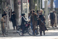 A Taliban fighter helps one of the injured in an explosion incident to get away from the explosion site, in Kabul, Afghanistan, Friday, Sept. 23, 2022. An explosion went off near a mosque in Afghanistan's capital of Kabul on Friday, with police confirming casualties. A column of black smoke rose into the sky and shots rang out several minutes after the blast in the city's diplomatic quarter. (AP Photo/Ebrahim Noroozi)