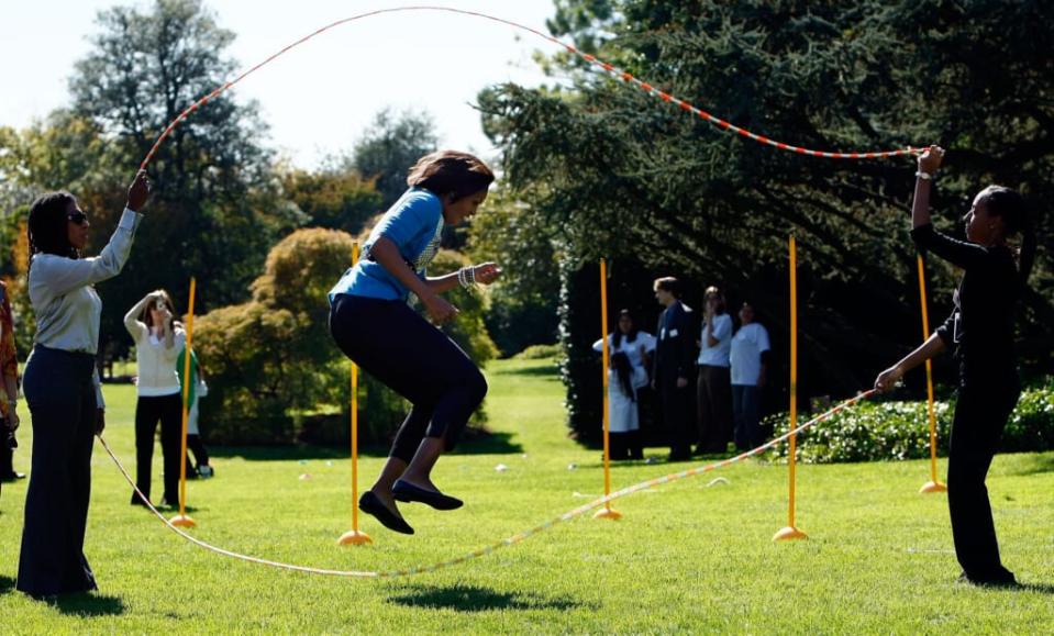 U.S. first lady Michelle Obama jump ropes “Double Dutch” on the South Lawn of the White House during an event promoting exercise and healthy eating for children October 21, 2009 in Washington, DC. The Healthy Kids Fair included events on cooking healthy meals and emphasized children getting a proper amount of outdoor exercise each day. (Photo by Win McNamee/Getty Images)