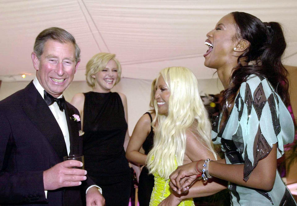 The Prince of Wales shares a joke with supermodels Sophie Dahl (second left), Naomi Campbell (right) and fashion designer Donatella Versace (centre), at the 'Its Fashion' charity gala dinner at Waddesdon Manor, Buckinghamshire.   * The dinner, in aid of the Macmillan Cancer Relief charity, was attented by fashion designers, models and celebrities.   (Photo by John Stillwell - PA Images/PA Images via Getty Images)