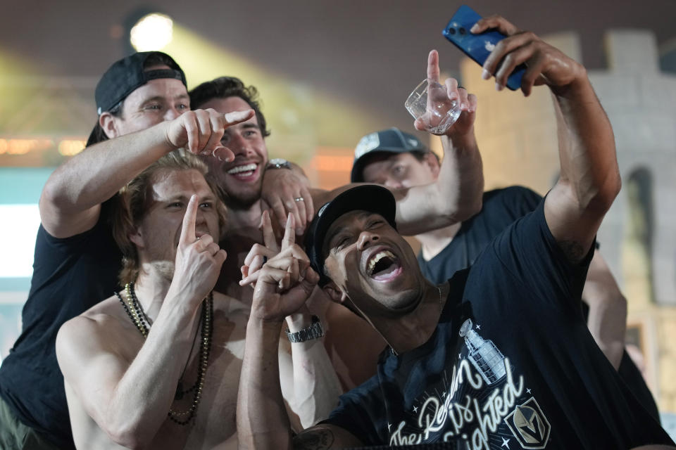 Vegas Golden Knights right wing Keegan Kolesar takes a selfie with teammates during a rally after a parade along the Las Vegas Strip for the NHL hockey champions Saturday, June 17, 2023, in Las Vegas. (AP Photo/John Locher)