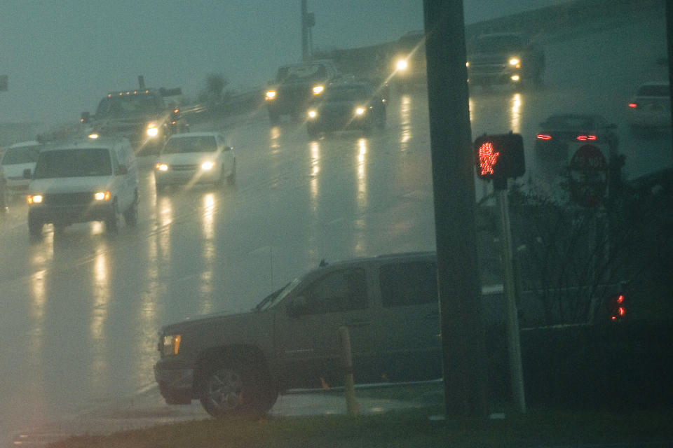 Traffic moves in heavy rain in Fort Walton Beach, Fla., on Tuesday, Nov. 26, 2013. A cold front associated with the massive storm moving across the country is expected to plunge temperatures by Thanksgiving. Safe travel in bad weather comes down to speed, according to Bill Van Tassel, manager of driver education for AAA. "It's much harder to get into trouble if you're going at a speed where your tires can maintain traction on the surface," says Van Tassel. (AP Photo/Northwest Florida Daily, Mark Kulaw)