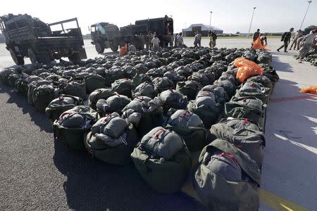 U.S. second cavalry regiment soldiers pack parachutes during the "Steadfast Javelin II" military exercise in the Lielvarde air base, September 6, 2014. REUTERS/Ints Kalnins