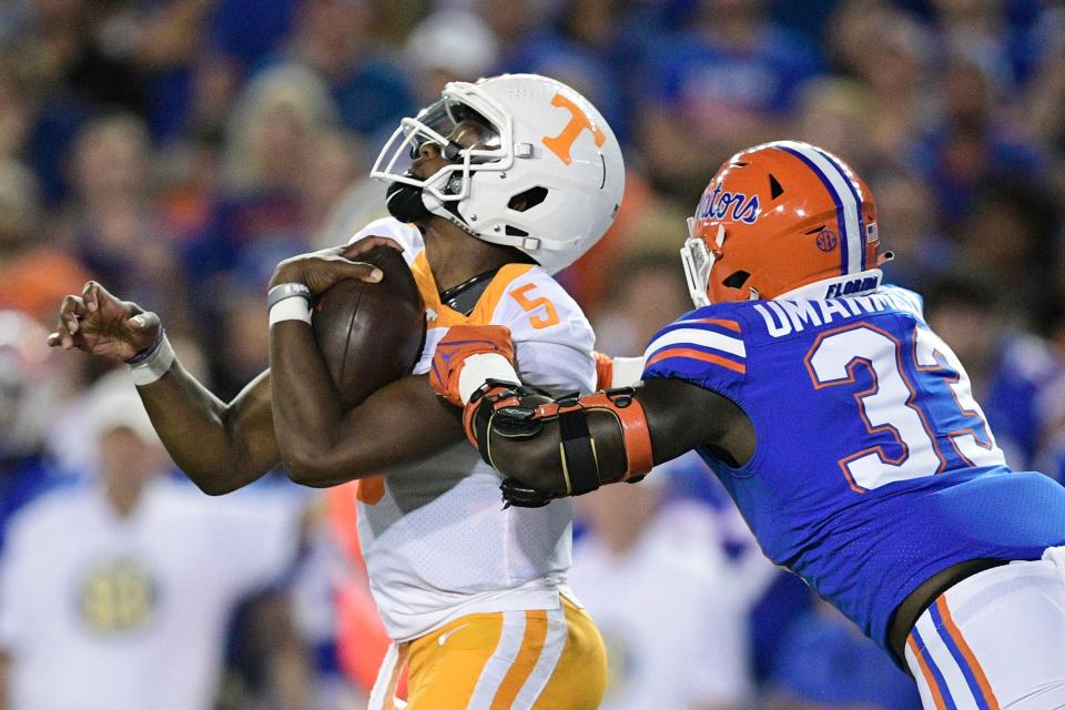 Tennessee quarterback Hendon Hooker (5) is tackled by Florida defensive lineman Princely Umanmielen (33)  during the first quarter of an NCAA football game against Florida at Ben Hill Griffin Stadium in Gainesville, Florida on Saturday, Sept. 25, 2021.