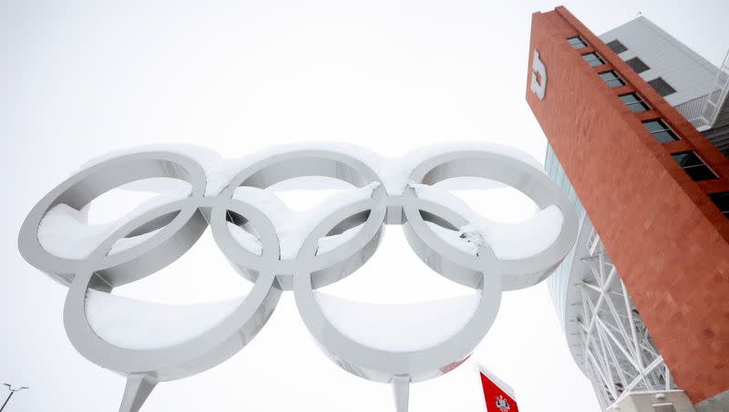 The Olympic rings are pictured covered in snow at the Olympic and Paralympic Cauldron Plaza in Salt Lake City, on Wednesday, Feb. 22, 2023.