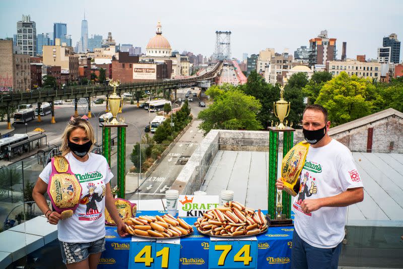 Current world record holder Chestnut and current women's champion Sudo pose for a picture during the official weigh-in ceremony for the Nathan's Famous Fourth of July International Hot Dog Eating Contest, in New York