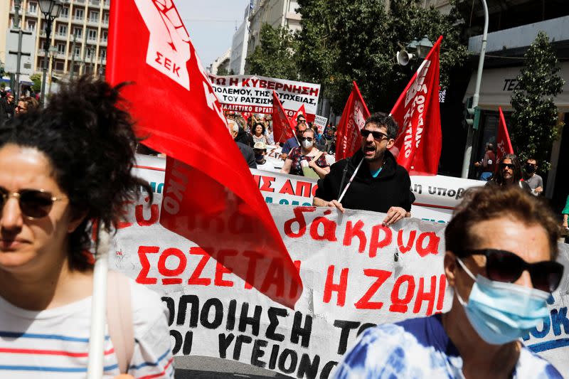 Protesters take part in a rally commemorating May Day in Athens