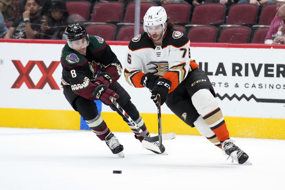 Anaheim Ducks defenseman Josh Mahura (76) skates away from Arizona Coyotes center Nick Schmaltz during the second period of an NHL hockey game Friday, April 1, 2022, in Glendale, Ariz. (AP Photo/Rick Scuteri)