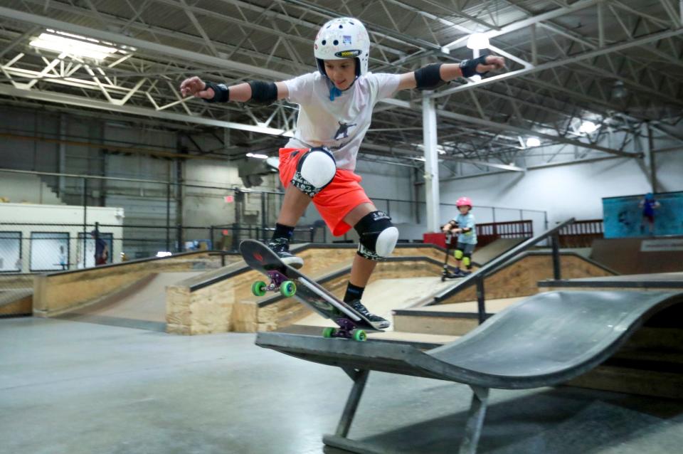 John Coleman 10, of Dexter, practices a trick during the skate clinic held at Modern Skate Park on Monday, July 10, 2023. 