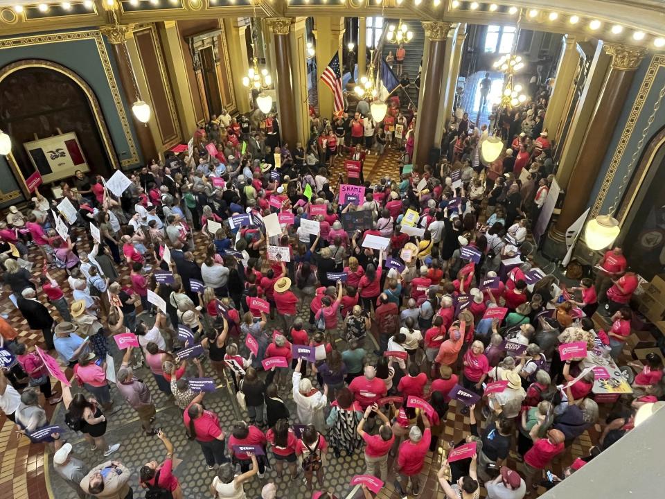 State Rep. Jennifer Konfrst speaks to protesters rallying at the Iowa Capitol rotunda.