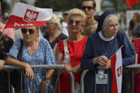 People attend the ceremony marking the Polish Army Day in Warsaw, Poland, Monday, Aug. 15, 2022. The Polish president and other officials marked their nation's Armed Forces Day holiday Monday alongside the U.S. army commander in Europe and regular American troops, a symbolic underlining of NATO support for members on the eastern front as Russia wages war nearby in Ukraine. (AP Photo/Michal Dyjuk)