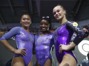 Simone Biles of the United States, center and gold medal, Sunisa Lee of the United States, left, and silver medal, and Angelina Melnikova of Russia, right and bronze medal, pose after the floor exercise in the women's apparatus finals at the Gymnastics World Championships in Stuttgart, Germany, Sunday, Oct. 13, 2019. (AP Photo/Matthias Schrader)