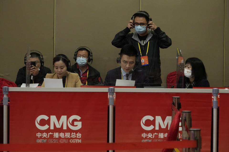 Chinese journalists work behind a work space for China Media Group at a press conference held on the sidelines of the 20th Party Congress in Beijing on Oct. 20, 2022. China's ruling Communist Party has long relied on a critically important and secretive internal reference system to learn about issues considered too sensitive for the public to know. But as Chinese leader Xi Jinping tightens censorship and consolidates his rule, Chinese academics and journalists say even this internal system is struggling to give frank assessments. (AP Photo/Ng Han Guan)