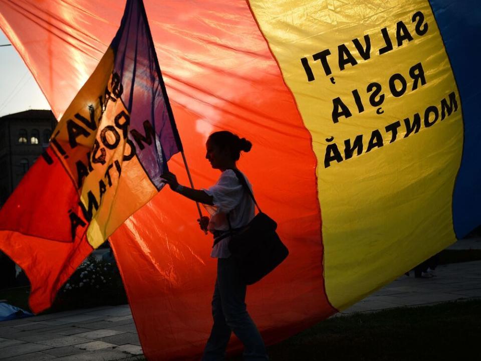  A protester holds a flag reading Save Rosia Montana during the demonstrations in Bucharest, in 2013.