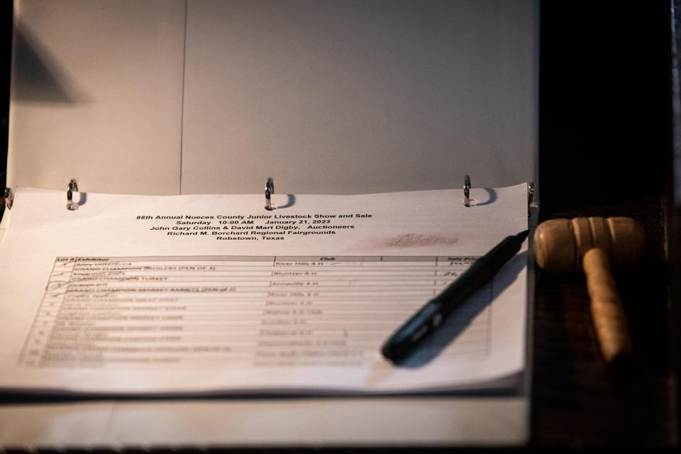 The auctioneer's gavel and binder at the Nueces County Junior Livestock Show's Blue Ribbon Sale on Saturday, Jan. 21, 2023, in Robstown, Texas.