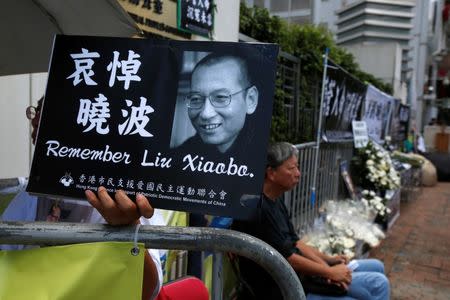 Pro-democracy activists mourn the death of Nobel Laureate Liu Xiaobo, outside China's Liaison Office in Hong Kong, China July 14, 2017. REUTERS/Bobby Yip//Files