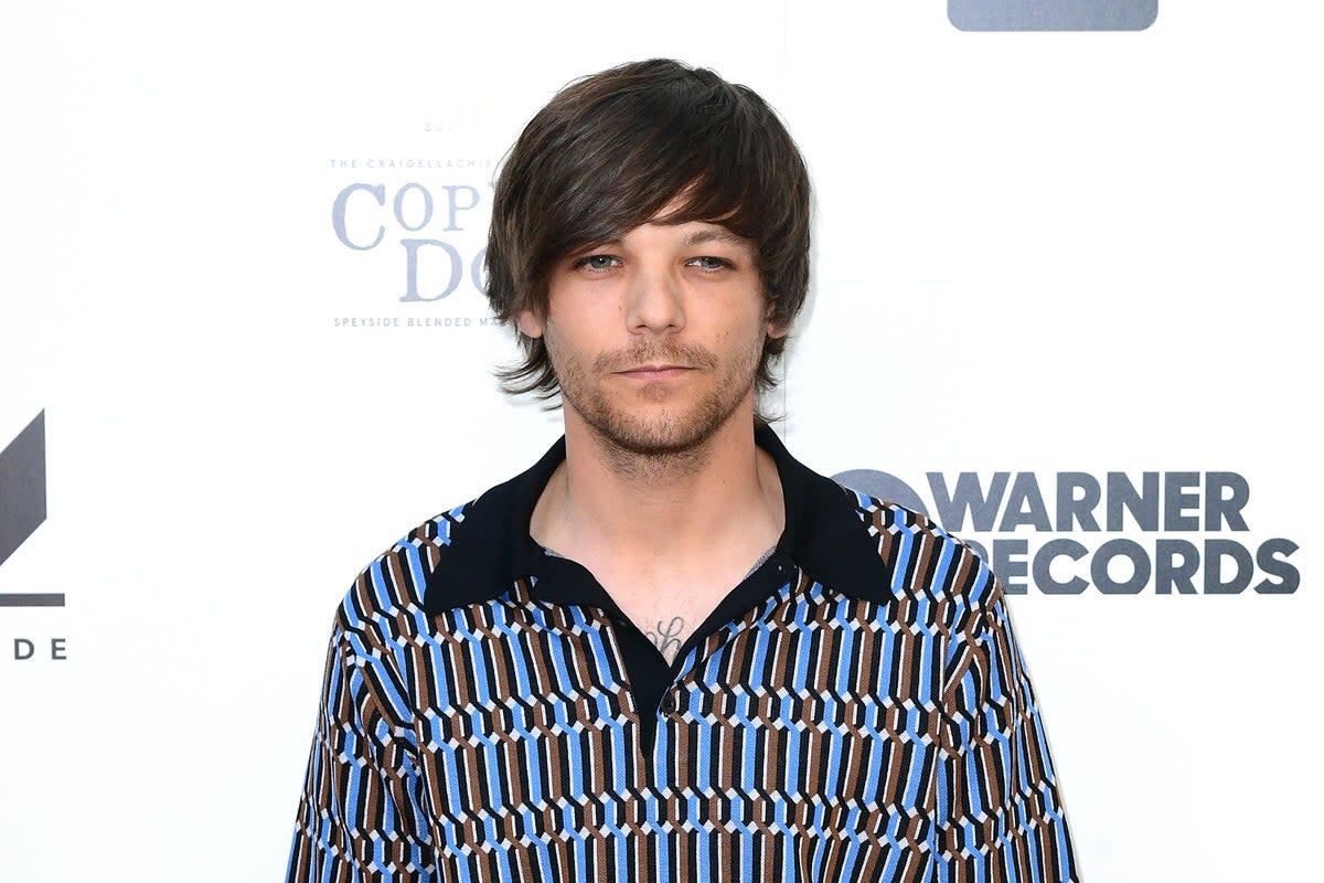 Louis Tomlinson has admitted to being envious of Harry Styles solo success  (PA Archive)