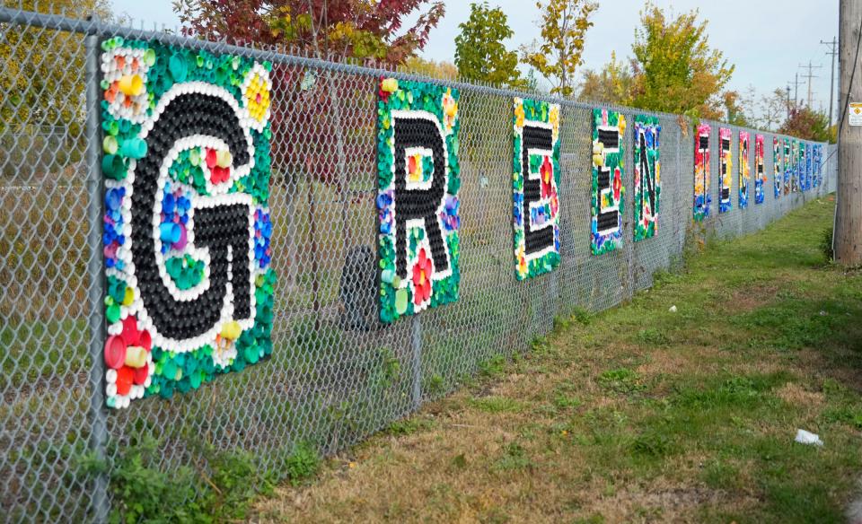 A colorfully decorated fence lines the outside of Green Tech Station, an open-air classroom, greenspace and a green infrastructure demonstration site at 4101 N. 31st St. in Milwaukee on Wednesday, Oct. 18, 2023. The site provides opportunities to learn about the environment while redirecting stormwater runoff and allows for research and product testing for water-based technologies.