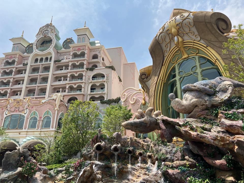 Sorcerer Mickey stands outside Tokyo DisneySea Fantasy Springs Hotel. According to the port's lore, a duchess discovered the magical waters of Fantasy Springs and built a chateau so she and her guests could enjoy the beauty.