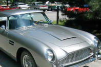 <b>1) Aston Martin DB5:</b> <br>The beauty DB5 surfaces the moment you think of James Bond. Seen for the first time in the 1964 film ‘Goldfinger’, the luxury car came powered by a 282-horsepower 4.0-liter engine. It was much ahead of its time with amenities such as reclining seats, wool pile carpets, electric windows, etc.