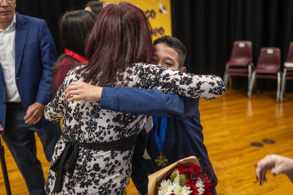 Luis Orlando Ruiz Medina gets a hug after winning Saturday's competition, which is the only Spanish language spelling bee in Central Texas.