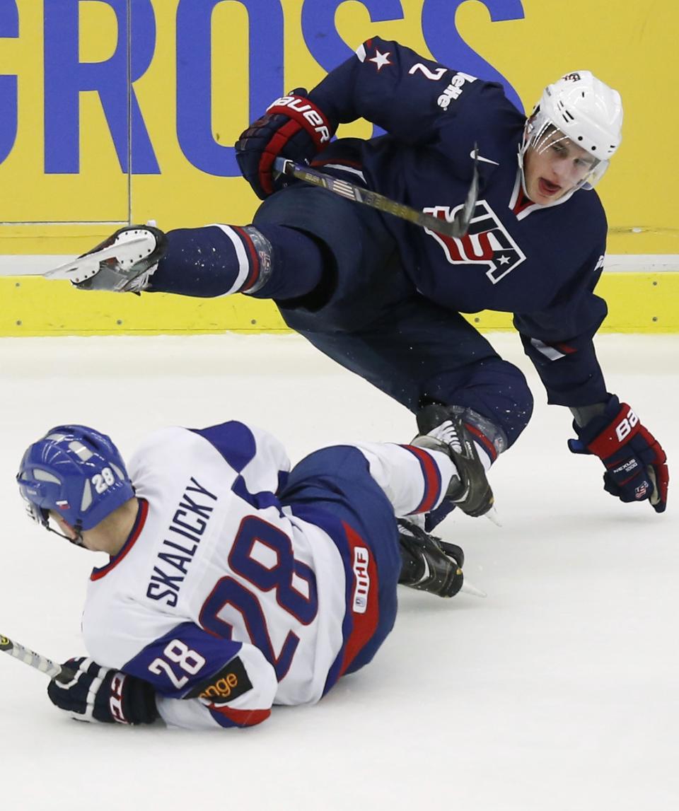 Slovakia's Skalicky checks Skjei of the U.S. during their IIHF World Junior Championship ice hockey game in Malmo