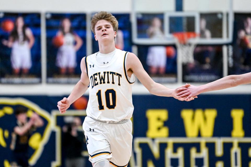 DeWitt's Bryce Kurncz celebrates after a 3-pointer against Grand Ledge during the third quarter on Friday, Feb. 3, 2023, at DeWitt High School.