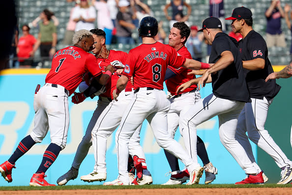 CLEVELAND, OH – SEPTEMBER 19: Cleveland Guardians second baseman Andres Gimenez (0) is mobbed by teammates after hitting a walk-off single to drive in the playoff-clinching run during the tenth inning of the Major League Baseball game between the Minnesota Twins and Cleveland Guardians on September 19, 2024, at Progressive Field in Cleveland, OH. (Photo by Frank Jansky/Icon Sportswire via Getty Images)