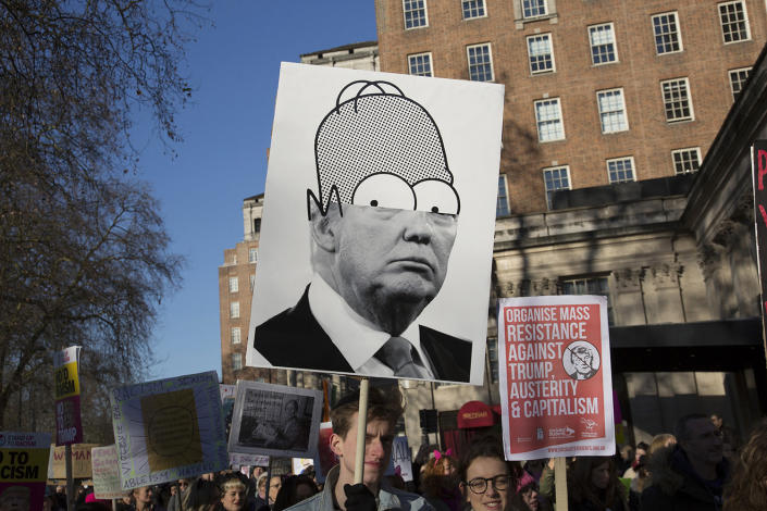 <p>People hold signs during the Women’s March in London, to coincide with the first day of Donald Trump’s Presidency, Jan. 21,2017. (Photo: Mike Kemp/In Pictures via Getty Images) </p>